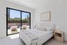 Bedroom featuring access to outside and light tile patterned floors