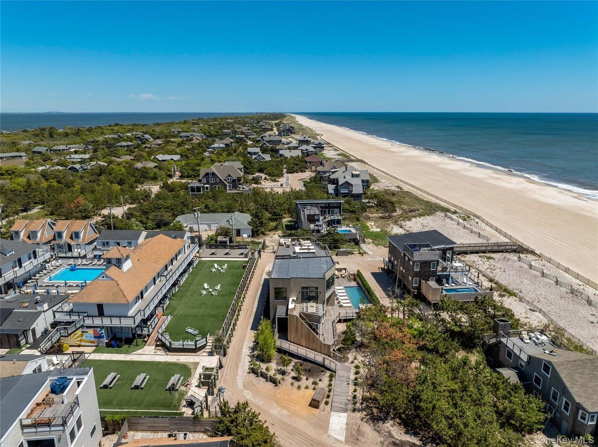 Drone / aerial view of unending shoreline and a pool area