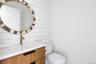 Half bathroom with vanity and toilet