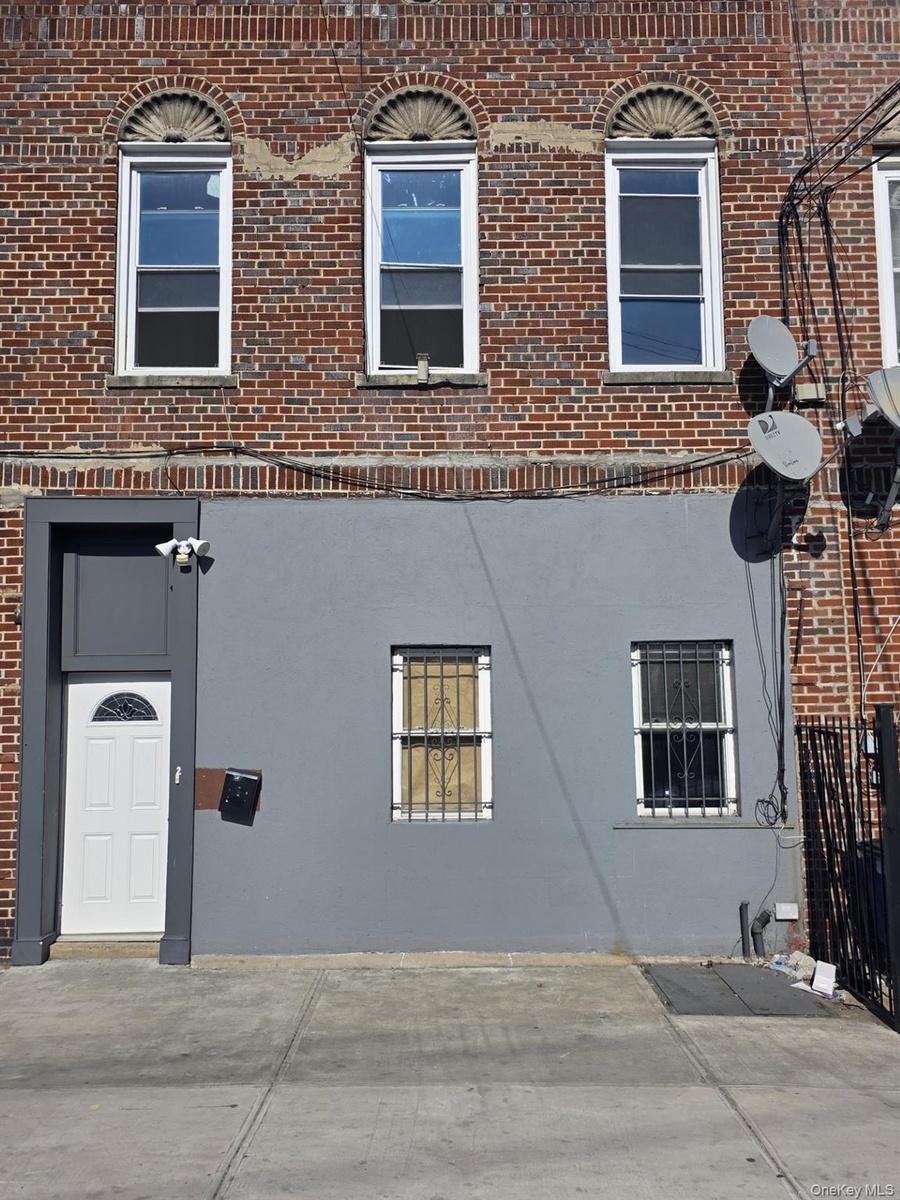View of property exterior with brick siding