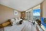 one-miami-east-3110-living-room-bay-view-floor-ceiling-glass-hardwood