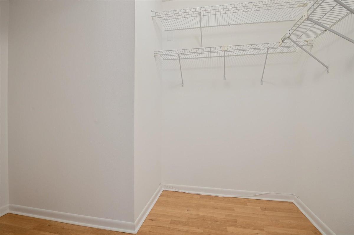 PRIMARY BEDROOM WALK-IN CLOSET.