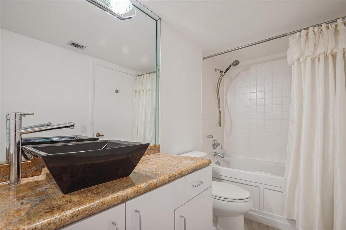 GUEST BATHROOM WITH A COMBO TUB/SHOWER.