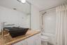 GUEST BATHROOM WITH A COMBO TUB/SHOWER.