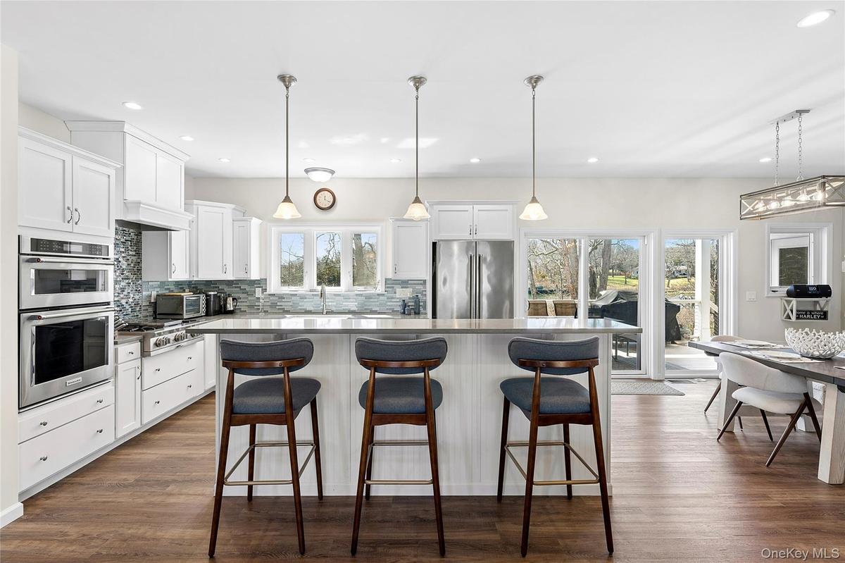 A beautifully executed high-end custom kitchen designed to capture both light and waterfront views at every turn