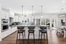 A beautifully executed high-end custom kitchen designed to capture both light and waterfront views at every turn