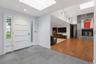 Entryway featuring gray tile flooring and a white paneled door with side-lites