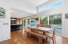 Wood-finish flooring throughout, with a vaulted ceiling and transom windows