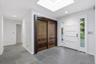 Entryway featuring a skylight, slate tile flooring, a solid white panel door with sidelights, and recessed lighting