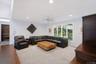 Carpeted living area featuring recessed lighting, a ceiling fan, and large windows