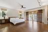 Hardwood flooring, ceiling fan, large windows, sliding glass doors, built-in track lighting