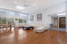 Wood-finish flooring, high ceilings, multiple skylights, recessed lighting, and expansive windows