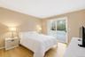 Wood-finish flooring, neutral wall tones, and a sliding glass door providing exterior access