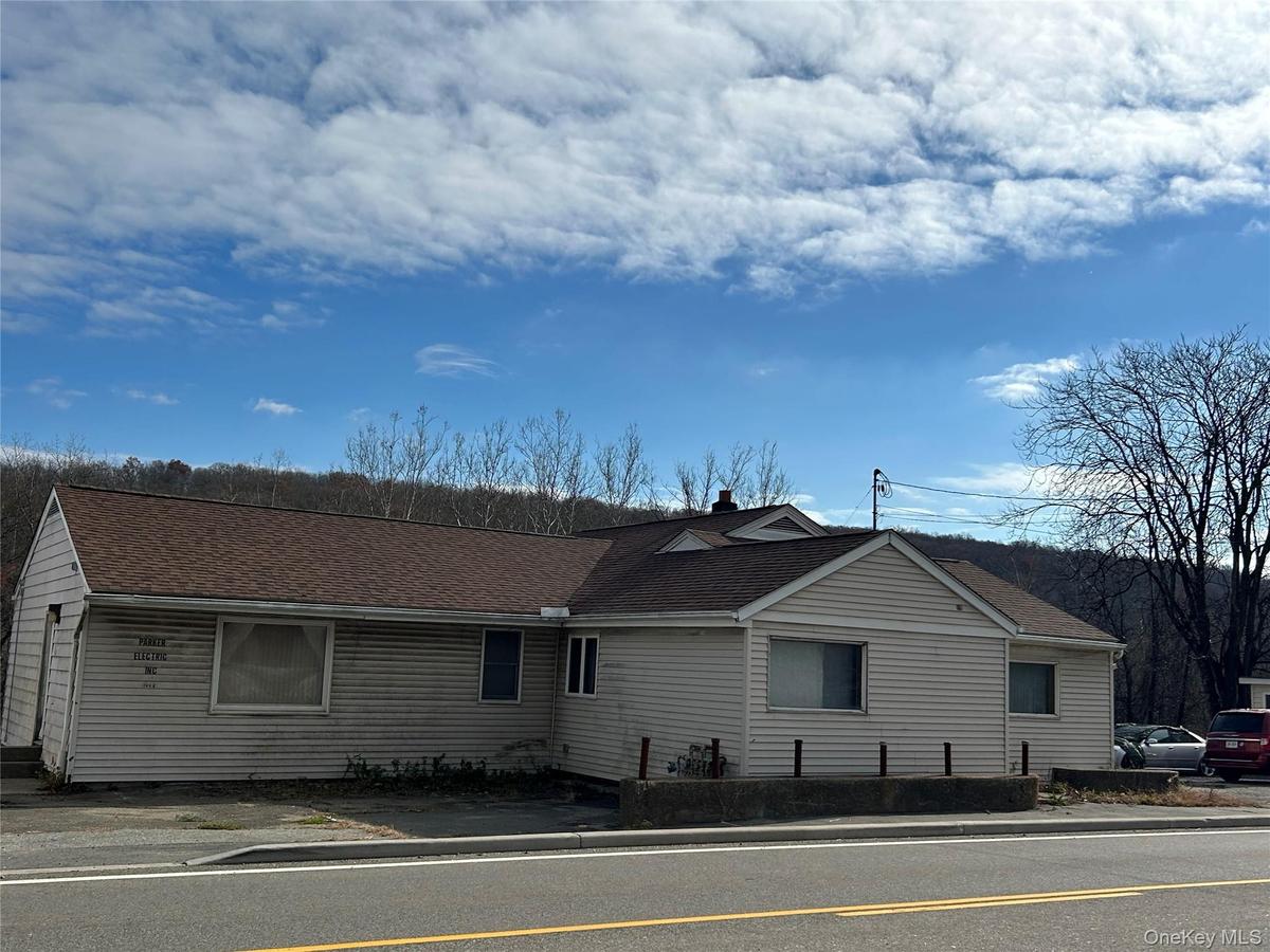 View of front facade featuring roof with shingles