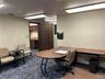 Home office featuring built in desk and dark colored carpet