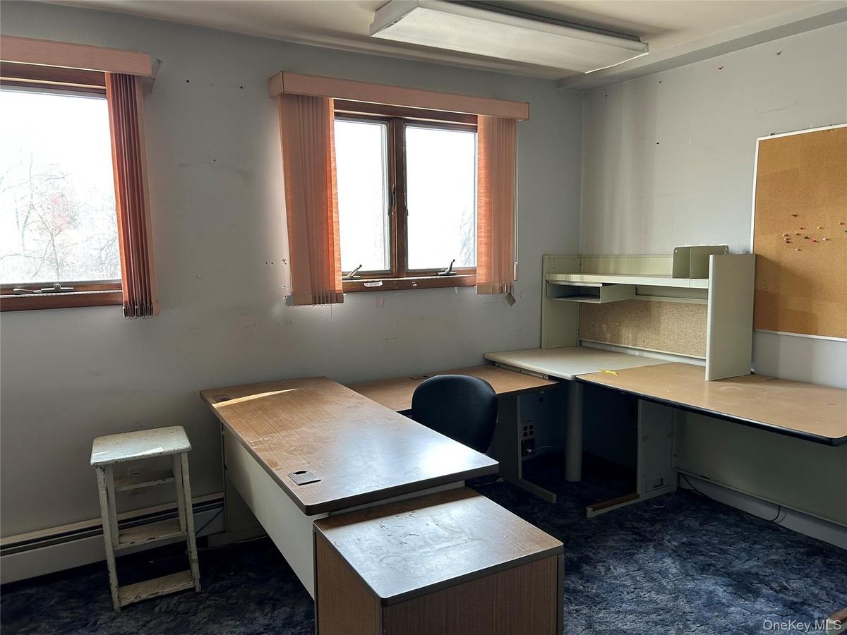 Unfurnished office with a baseboard radiator