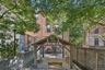 Back of house featuring a fenced backyard, a patio, and brick siding