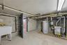 Unfinished below grade area featuring water heater