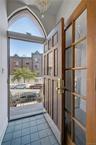 Doorway to outside featuring tile patterned floors and a chandelier