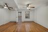 Spare room featuring a ceiling fan, a baseboard heating unit, and light wood-type flooring