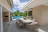 Rear Patio Virtual Staged with a Granite outdoor table.