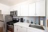 Kitchen with a sink, white cabinetry, appliances with stainless steel finishes, and backsplash