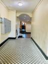 Hall featuring baseboards, mail area, a textured ceiling, ornamental molding, and arched walkways