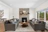 Living room featuring wood finished floors, a fireplace, and recessed lighting