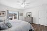 Primary ensuite with large walk in closets and access to balcony