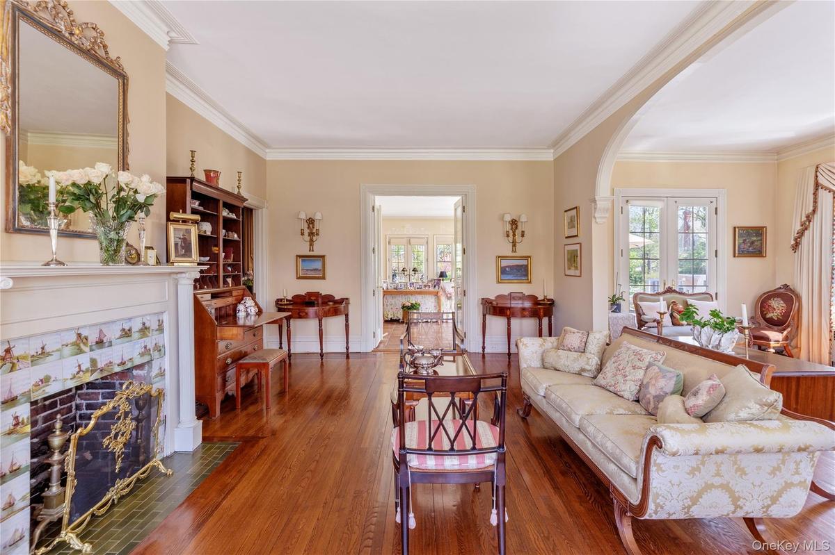 With Hardwood Floors and Original Delft Tiles around Fireplace. Entrance to Butler's Pantry and Great Room/Sunroom