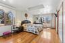 Master Bedroom featuring SkyLight,  light wood-style floors, a closet, a baseboard radiator, and recessed lighting