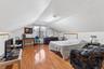 Guest Bedroom with light wood-style floors and baseboard heating