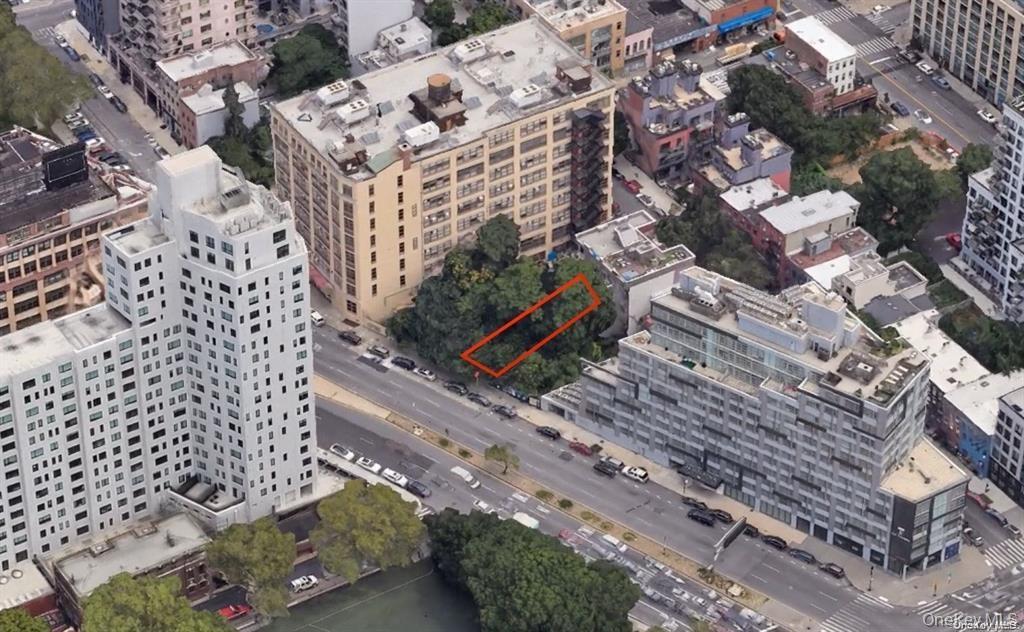 Aerial view of property's location featuring property parcel outlined and nearby urban area