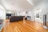 Living room featuring light wood-type flooring and crown molding