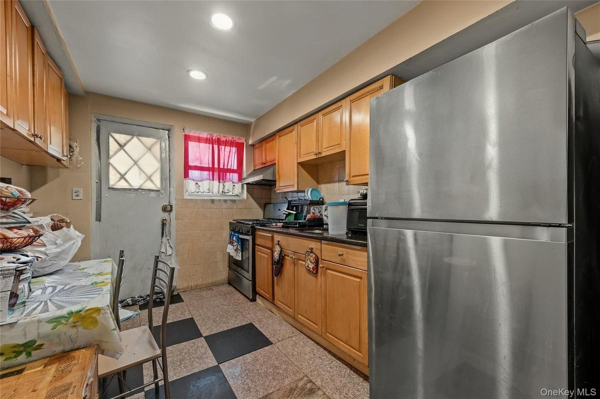Kitchen with stainless steel appliances, dark flooring, wood finish cabinetry, and recessed lighting