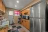 Kitchen with stainless steel appliances, dark flooring, wood finish cabinetry, and recessed lighting