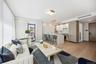 Living area with light wood finished floors and baseboards