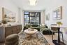 Living area featuring light wood-style flooring, baseboards, and a wall of windows