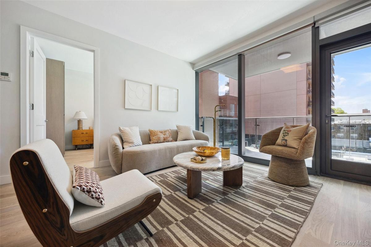 Living room with light wood finished floors and plenty of natural light