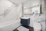 Full bathroom with tile walls, toilet, bathtub / shower combination, and vanity