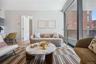 Living area with wood finished floors, baseboards, and expansive windows