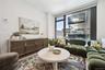 Living room with wood finished floors and floor to ceiling windows