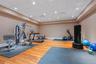 Dedicated fitness space featuring wood-finish flooring, recessed lighting, and a neutral wall palette