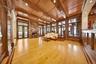 Living area featuring wooden ceiling, french doors, light wood-style floors, a fireplace, and a decorative wall