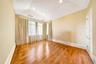 Empty room with wood finished floors, lofted ceiling, and recessed lighting