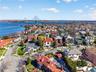 Aerial view of residential area with a notable bridge and a large body of water