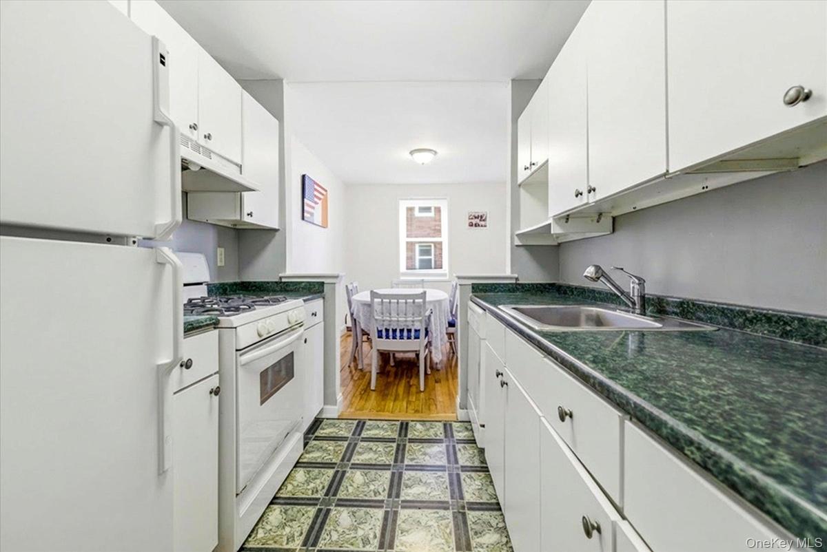 Long line updated kitchen w matching appliances flows into the dining area