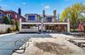 Back of house with a balcony, stucco siding, a patio, and a chimney