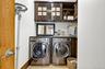 Laundry area with light tile patterned flooring and separate washer and dryer