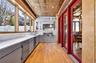 Kitchen featuring gray cabinetry, light wood-type flooring, light countertops, an ornate ceiling, and decorative backsplash